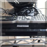 E06. Universal remote control base and remote. - $120